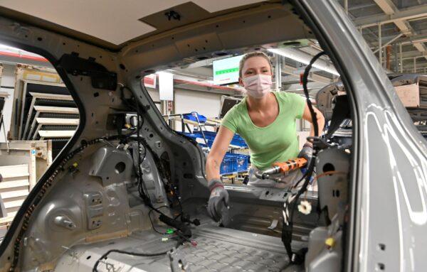 A technician works at the assembly line of Volkswagen's electric ID.3 car in Zwickau, Germany on June 23, 2021. (Matthias Rietschel/Reuters)