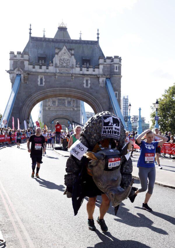 Runners in fancy dress cross over Tower Bridge during the London Marathon 2021 in London, on Oct. 3, 2021. (Steven Paston/PA)
