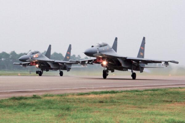 Two Chinese SU-30 fighter jets take off from an unspecified location to fly a patrol over the South China Sea in a file photo. (Jin Danhua/Xinhua via AP)