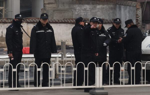 Police officers stand guard outside the No. 2 Intermediate People's Court, where human rights lawyer Pu Zhiqiang was being sentenced, in Beijing on Dec. 22, 2015. (Greg Baker/AFP via Getty Images)