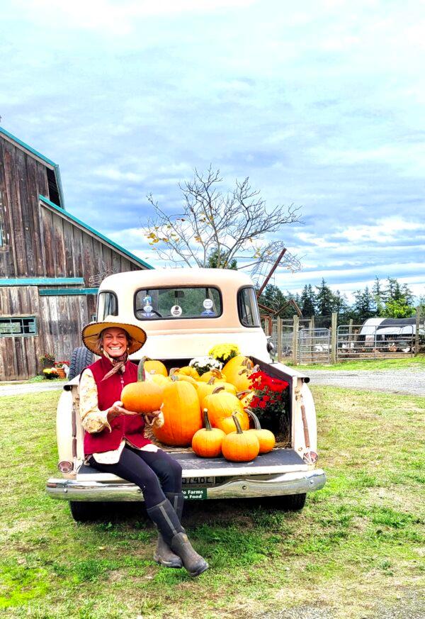 Farmer Lori Ann David is partial to Sugar Pie pumpkins for cooking: "You can't beat the flavor." The enormous jacks behind her, while edible, are best suited for decorating. (Courtesy of Lori Ann David)
