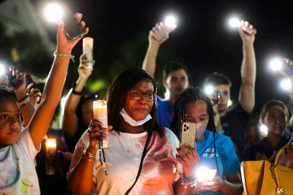 Attendees raise candles and phone flashlights to music during a candlelight vigil for Miya Marcano at Arden Villas in Orlando, Fla., Oct. 1, 2021. (Chasity Maynard/Orlando Sentinel via AP)