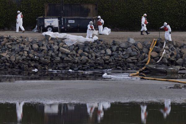 Clean-up crews work to mitigate the damage in an ecological estuary after a major oil spill off the coast of California came ashore in Huntington Beach, Calif., U.S. on Oct. 4, 2021. (Mike Blake/Reuters)