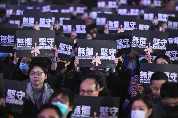 Teachers and pro-democracy supporters hold placards saying “No Fear to White Terrorism” as they take part in a rally in the central district of Hong Kong on Jan. 3, 2020. (Philip Fong/ AFP)