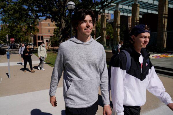 University of Michigan hockey players Owen Power (L) and Kent Johnson walk on campus after class before their NCAA college hockey practice in Ann Arbor, Mich., on Sept. 29, 2021. (Paul Sancya/AP Photo)