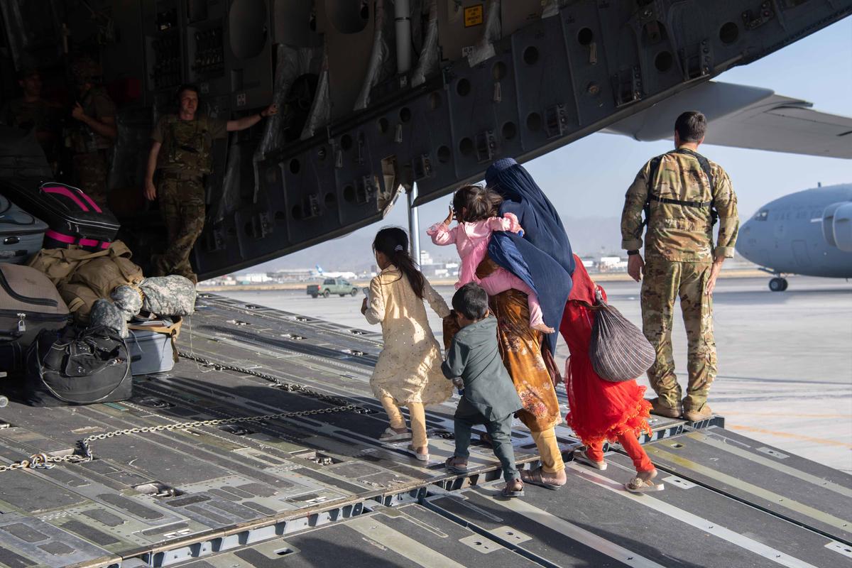 U.S. Air Force servicemembers load passengers aboard a C-17 Globemaster III in support of the Afghanistan evacuation at Hamid Karzai International Airport (HKIA) on August 24, 2021 in Kabul, Afghanistan. (Master Sgt. Donald R. Allen/U.S. Air Forces Europe-Africa via Getty Images)