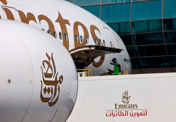 A picture shows an Emirates Airlines plane being unloaded the Dubai International Airport on Feb. 1, 2021. (Karim Sahib/AFP via Getty Images)