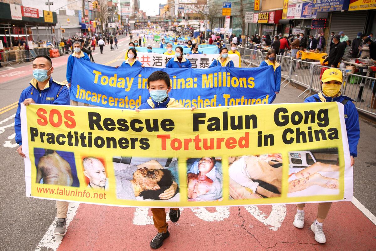 Falun Gong practitioners take part in a parade in Flushing, New York, on April 18, 2021, to commemorate the 22nd anniversary of the April 25 peaceful appeal of 10,000 Falun Gong practitioners in Beijing. (Samira Bouaou/The Epoch Times)
