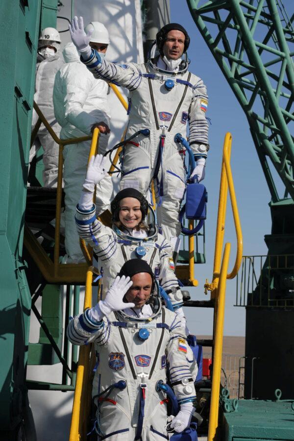 The International Space Station (ISS) crew members Russian cosmonaut Anton Shkaplerov, film director Klim Shipenko and actress Yulia Peresild wave farewell as they board the Soyuz MS-19 spacecraft for the launch at the Baikonur Cosmodrome, Kazakhstan on Oct. 5, 2021. (Roscosmos/via Reuters)