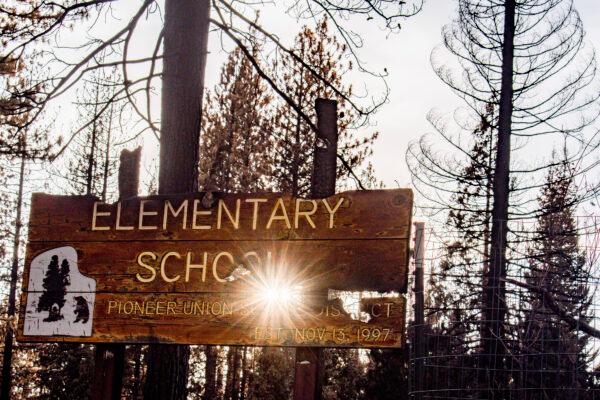 A broken sign amid the remains of Walt Tyler Elementary School in Grizzly Flats, Calif., on Sept. 26, 2021. (Jacquelin Mullinax/NTD News)