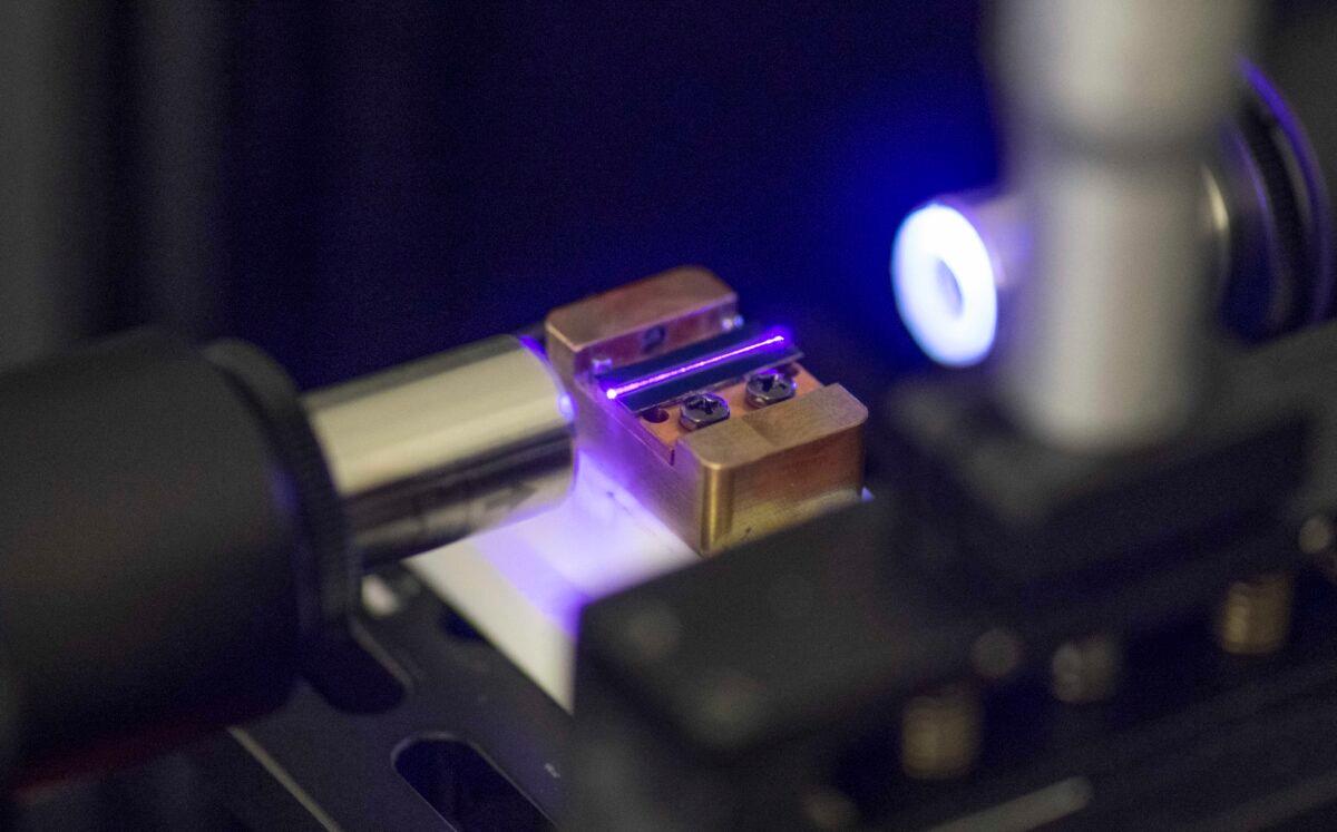 A laser tests the optical waveguide of a chip for quantum computing in a laboratory in Stuttgart, Germany, on Sept. 14, 2021. (Thomas Kienzle/AFP via Getty Images)