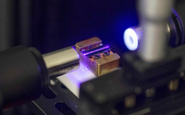 A laser tests the optical waveguide of a chip for quantum computing in a laboratory in Stuttgart, Germany, on Sept.14, 2021. (Thomas Kienzle/AFP via Getty Images)