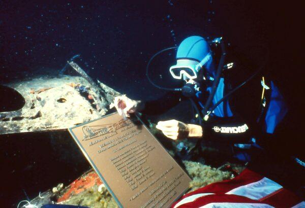 John Christopher Fine places the memorial plaque on the sunken B-17. (Courtesy of John Christopher Fine)