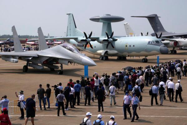 Visitors look at the Chinese military’s J-16D electronic warfare airplane at left and the KJ-500 airborne early warning and control aircraft at Airshow China 2021 in Zhuhai, southern China's Guangdong province, on Sept. 29, 2021. (Ng Han Guan/AP Photo)