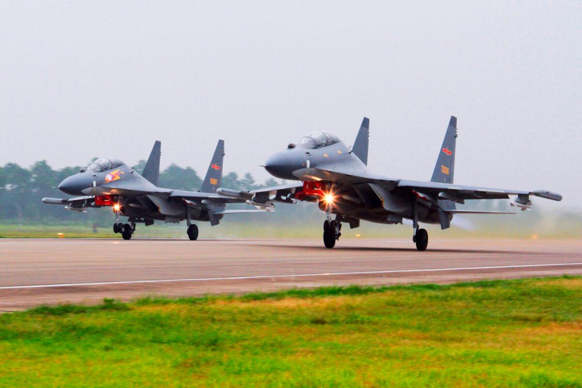 Two Chinese SU-30 fighter jets take off from an unspecified location to fly a patrol over the South China Sea in this undated photo. (Jin Danhua/Xinhua via AP)