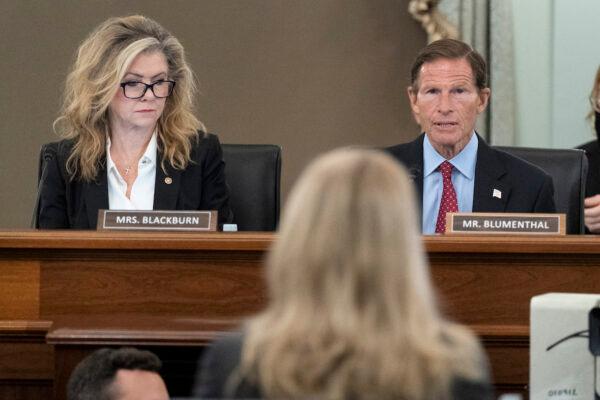 Sen. Marsha Blackburn (R-Tenn.), left, and Sen. Richard Blumenthal (D-Conn.), right, speak to former Facebook data scientist Frances Haugen, center, during a hearing of the Senate Commerce, Science, and Transportation Subcommittee on Consumer Protection, Product Safety, and Data Security, on Capitol Hill in Washington, Oct. 5, 2021. (AP Photo/Alex Brandon)
