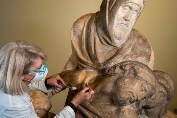 A conservator carefully cleans the "Bandini Pietà," one of Michelangelo's unfinished sculptures. (Claudio Giovannin/Courtesy of Opera di Santa Maria del Fiore)