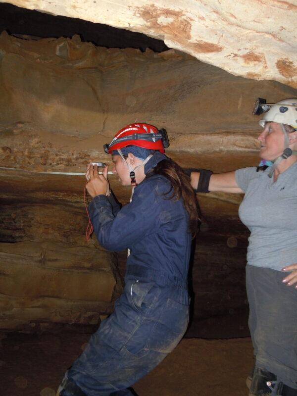 Lisa Troyer reading a compass with assistance from Elizabeth Winkler. (Ed Klausner/Cave Research Foundation)