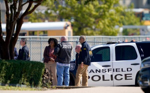 Law enforcement officers from different agencies gather in the parking lot of Timberview High School after a shooting inside the school located in south Arlington, Texas, on Oct. 6, 2021. (LM Otero/AP Photo)