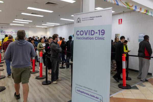 Members of the public wait to be vaccinated at a COVID-19 mass vaccination clinic in Midland, an eastern suburb of Perth, Australia, on Sep. 9, 2021. (AAP Image/Richard Wainwright)