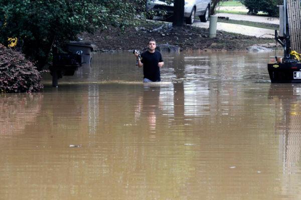 Michael Halbert wades through his flooded neighborhood in Pelham, Ala., on Oct. 7, 2021. (Jay Reeves/AP Photo)