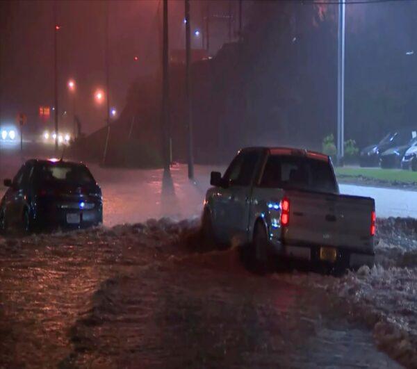 In this image taken from a video, vehicles drive through floodwaters in Pelham, Ala., on Oct. 6, 2021. (ABC 33/40/ AP Photo)