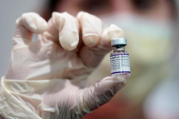 A health care worker holds a vial of the Pfizer COVID-19 vaccine at Jackson Memorial Hospital in Miami, Fla., on Oct. 5, 2021. (Lynne Sladky/AP Photo)
