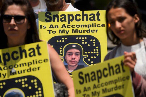 Family and friends of people who died after taking pills containing fentanyl carry signs as they protest near the Snap, Inc. headquarters, makers of the Snapchat social media application in Santa Monica, Calif., on June 4, 2021. (PATRICK T. FALLON/AFP via Getty Images)