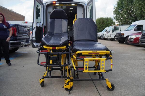 A normal stretcher (L) compared to a stretcher for the obese in front of a Care Med ambulance in Chattanooga, Tenn., on Oct. 4, 2021. (Jackson Elliott/The Epoch Times)