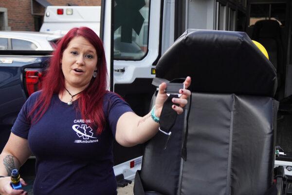 Candace Laymon holds the strap of a bariatric stretcher for a Care Med ambulance in Chattanooga, Tenn., on Oct. 4, 2021. (Jackson Elliott/The Epoch Times)