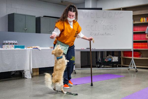 Three female inmates complete a dog training program at Theo Lacy Facility in Orange, Calif., on Oct. 7, 2021. (John Fredricks/The Epoch Times)
