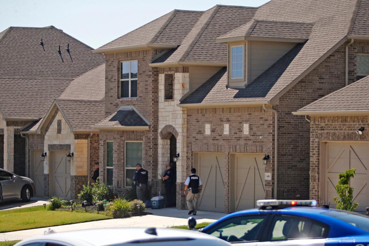Law enforcement search a home while looking for the suspect in a shooting at Timeberview High School in Arlington, Texas, on Oct. 6, 2021. (Stewart F. House/Getty Images)