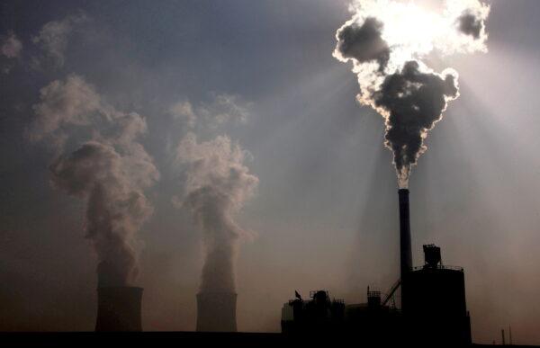 A coal-burning power plant behind a factory in the city of Baotou, in China's Inner Mongolia Autonomous Region, on Oct. 31, 2010. (David Gray/Reuters)