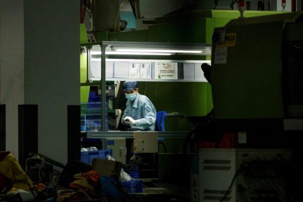 A man works at a manufacturing plant of Universal Electronics Inc in Qinzhou in Guangxi Autonomous Region, China, April 12, 2021. (Thomas Peter/Reuters)