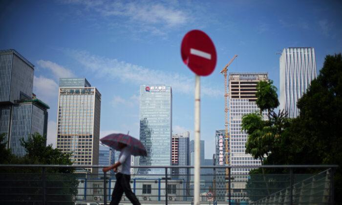 Chinese Property Developers Sell Shares As Default Woes Deepen