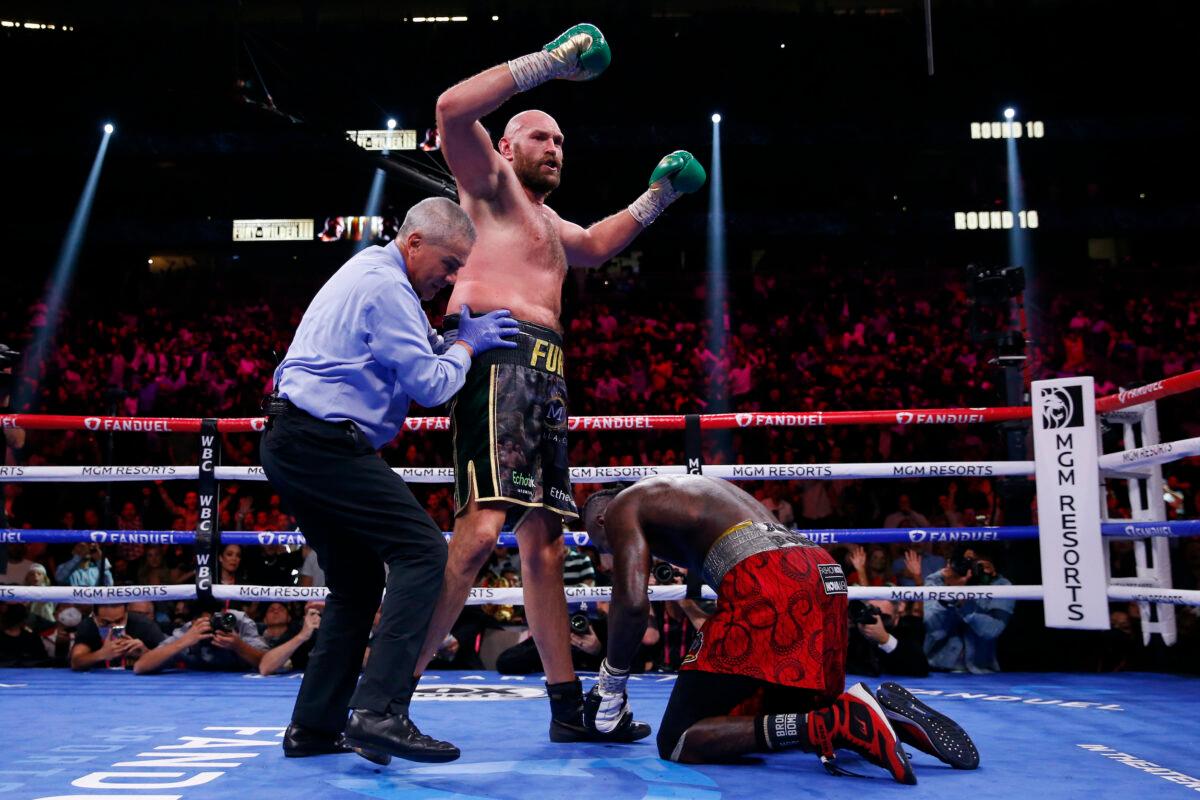 Tyson Fury, of England, knocks down Deontay Wilder in a heavyweight championship boxing match in Las Vegas, on Oct. 9, 2021. (Chase Stevens/AP Photo)