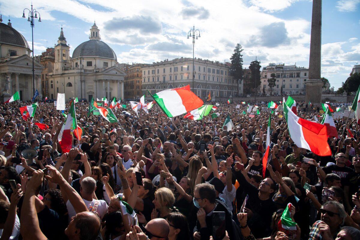 People wave national flags during a protest in Rome, on Oct. 9, 2021. (TIZIANA FABI/AFP via Getty Images)