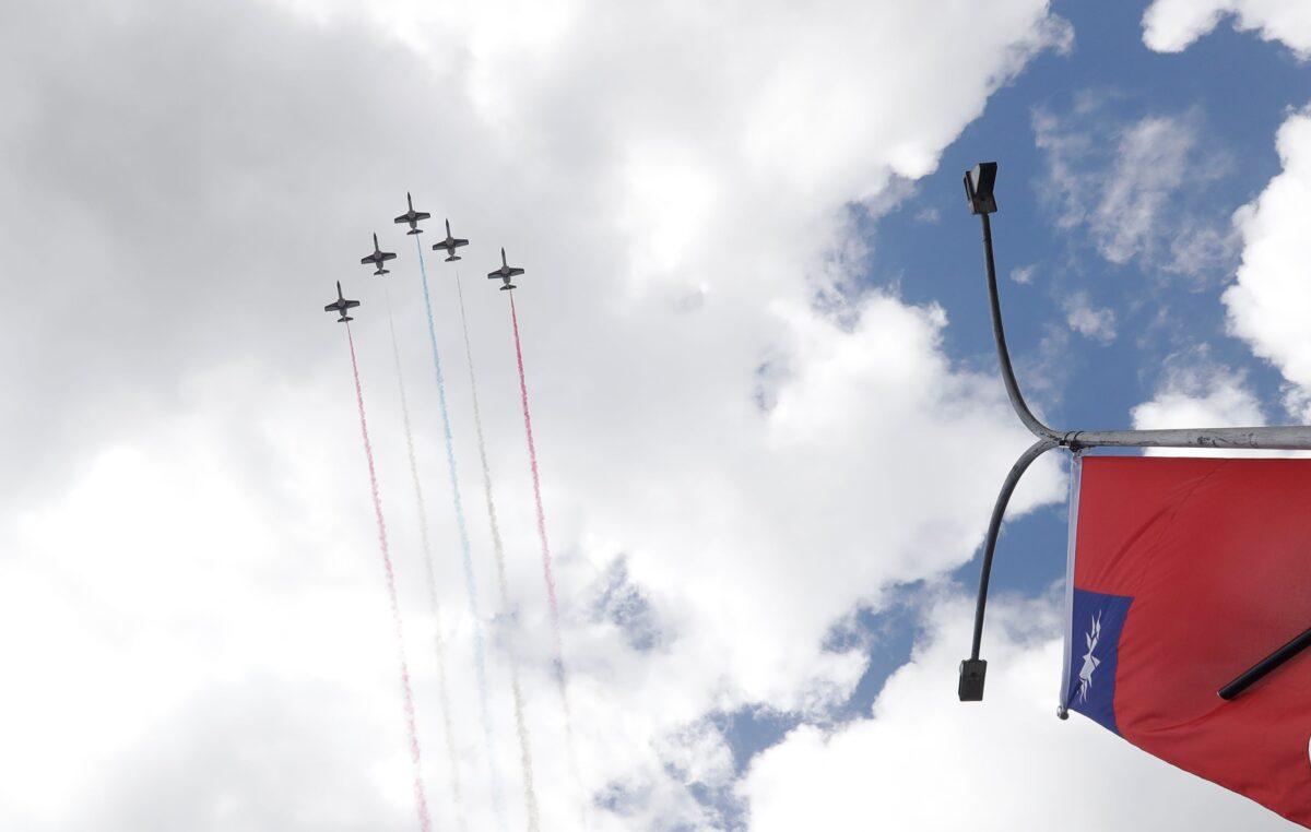 Thunder Tiger Aerobatics Team flies over President Office during National Day celebrations in Taipei, Taiwan on Oct. 10, 2021. (Chiang Ying-ying/AP Photo)