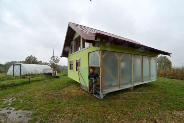 Vojin Kusic's stands in front of his rotating house, designed and built by 72-year-old Vojin Kusic in a town of Srbac, northern Bosnia, on Oct. 10, 2021. (Radivoje Pavicic/AP Photo)