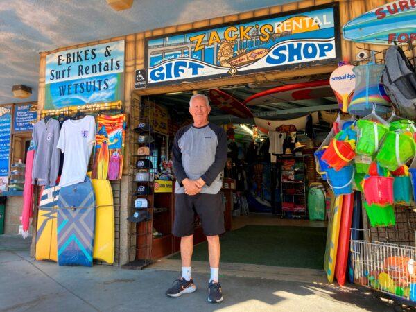 Mike Ali, the owner of Zack's shop near the Huntington Beach pier, waits for customers in Huntington Beach, Calif., on Oct. 10, 2021. (Amy Taxin/AP Photo)