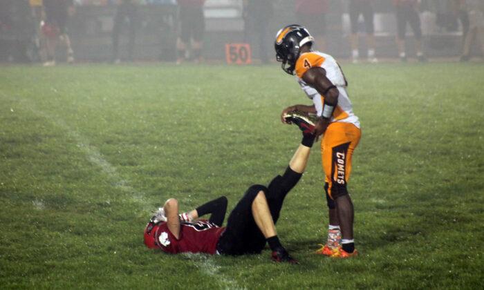 Football Mom Snaps Photo of Senior Player Helping Injured Opponent on Field—and It Goes Viral