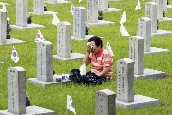 A South Korean woman cries as she mourns her relative who died in 1950 in the Korean War on the Korean Memorial Day at the Seoul National Cemetery in Seoul, South Korea, on June 6, 2004. (Chung Sung-jun/Getty Images)