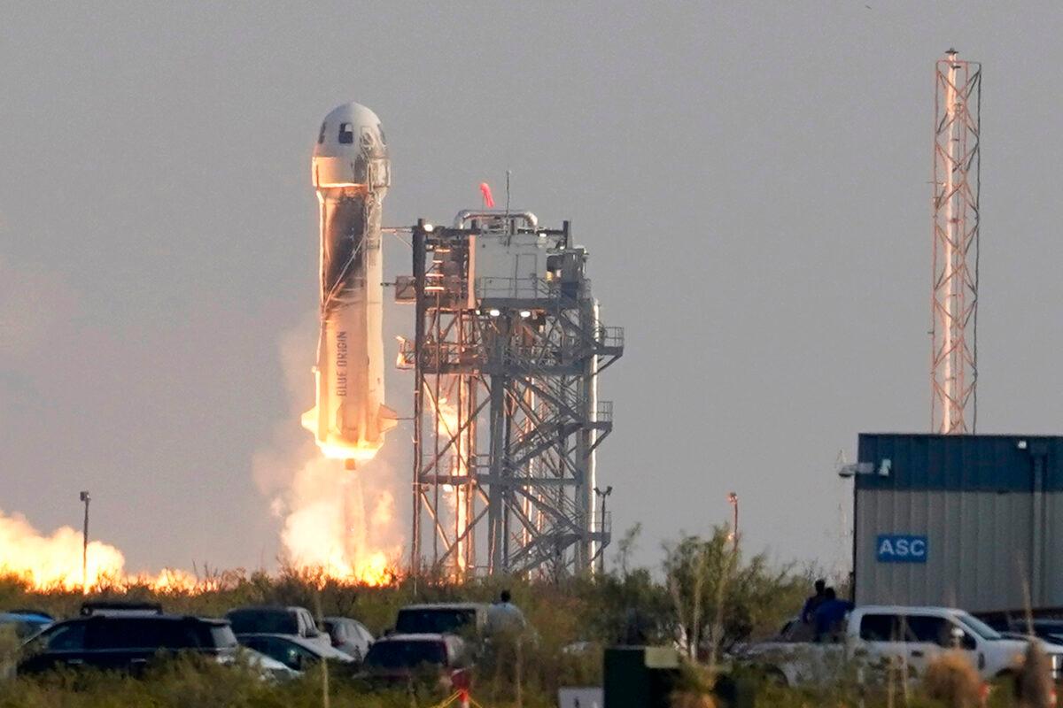 Blue Origin's New Shepard rocket launches, carrying passengers Jeff Bezos, founder of Amazon and space tourism company Blue Origin, his brother Mark Bezos, Oliver Daemen, and Wally Funk, from its spaceport near Van Horn, Texas, on July 20, 2021. (Tony Gutierrez/AP Photo)