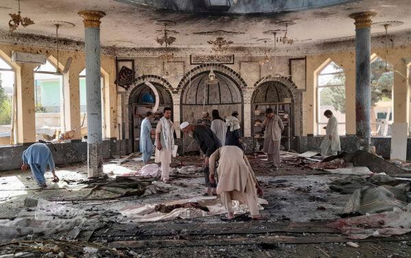 Afghans inspect the inside of a mosque following a bombing in Kunduz province northern Afghanistan, on Oct. 8, 2021. (Abdullah Sahil/AP Photo)