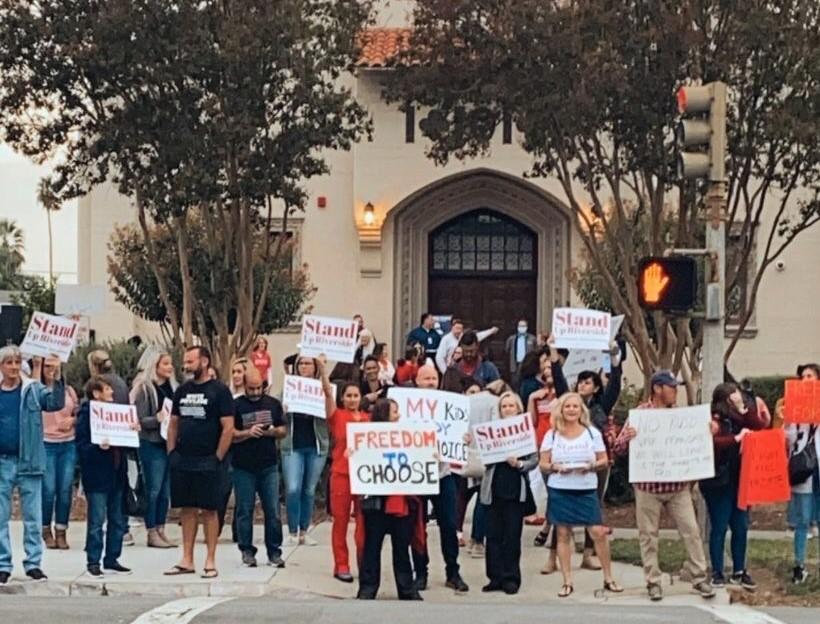 Parents and teachers hold signs in protest at Riverside Unified School District in Riverside, Calif., on Oct. 7, 2021. (Courtesy of Heather Knapp)