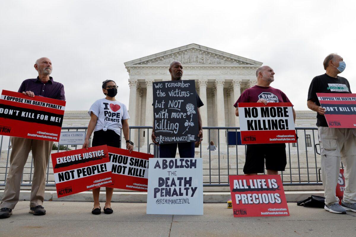 A small group of demonstrators rally against the death penalty outside the U.S. Supreme Court building, where justices were hearing arguments in the federal government's bid to reinstate Boston Marathon bomber Dzhokhar Tsarnaev's death sentence in Washington, on Oct. 13, 2021. (Jonathan Ernst/Reuters)