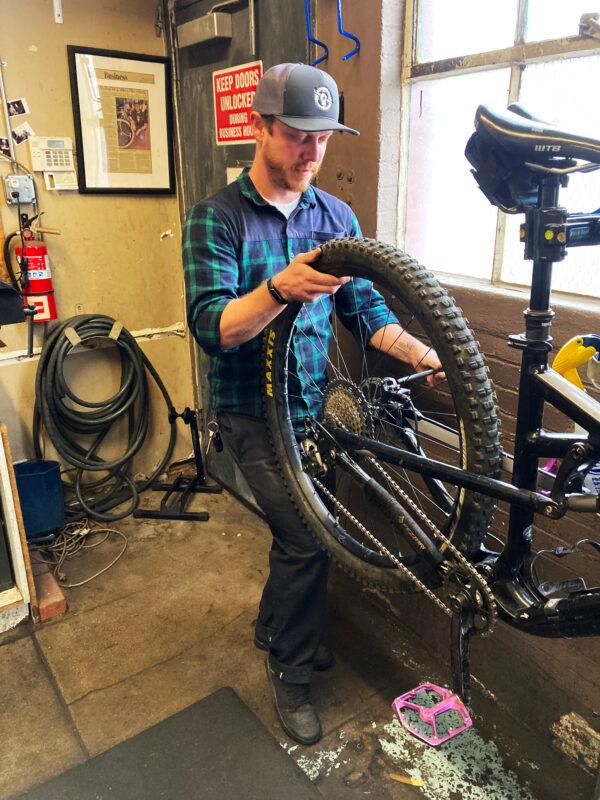 Chuck Seppanen, lead mechanic at Flagstaff Bicycle Revolution in Arizona, works on repairing a customer's bicycle on Oct. 12. In spite of a shortage of parts at many bicycle shops, assembly and repairs remain brisk. (Allan Stein/The Epoch Times)