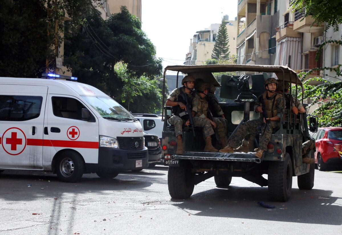 A Lebanese Red Cross vehicle is pictured as army soldiers are deployed after gunfire erupted near the site of a protest that was getting underway against Judge Tarek Bitar, who is investigating last year's port explosion, in Beirut, Lebanon, on Oct. 14, 2021. (Mohamed Azakir/Reuters)