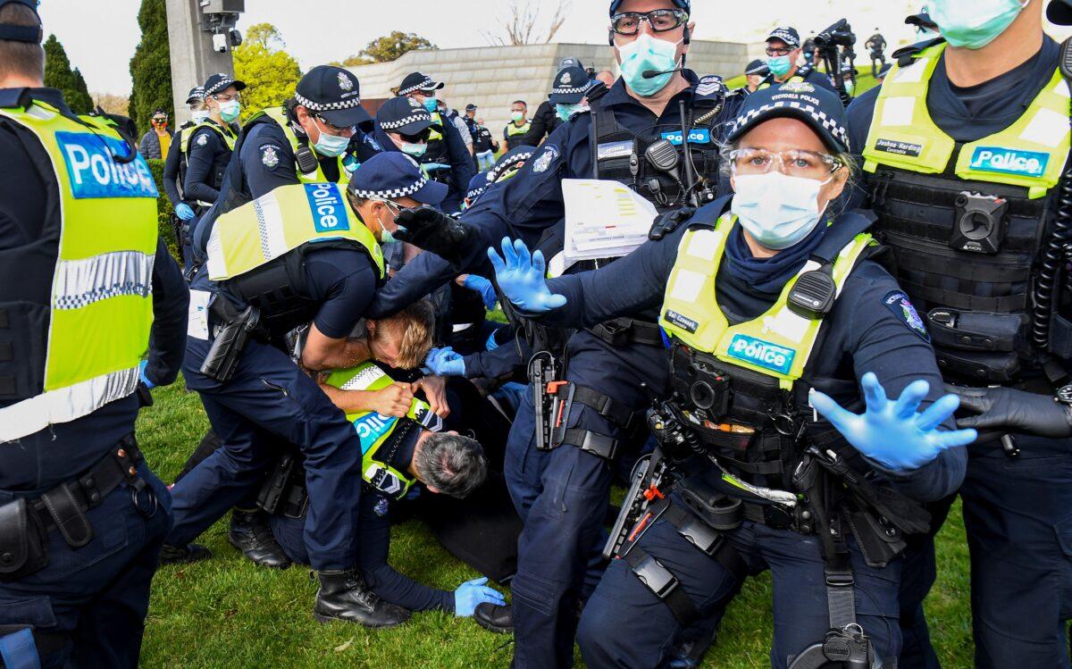 Police tackle demonstrators during a rally protesting the state’s strict lockdown laws in Melbourne, Australia, on Sept. 5, 2020. (William West/AFP via Getty Images)