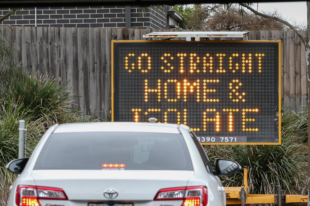 A sign reading “Go straight home and Isolate” at the exit of a drive-thru COVID-19 testing site at Highpoint shopping center in Melbourne, Australia, on July 4, 2020. (Asanka Ratnayake/Getty Images)